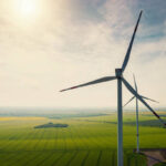 Aerial view of wind turbines and agriculture field